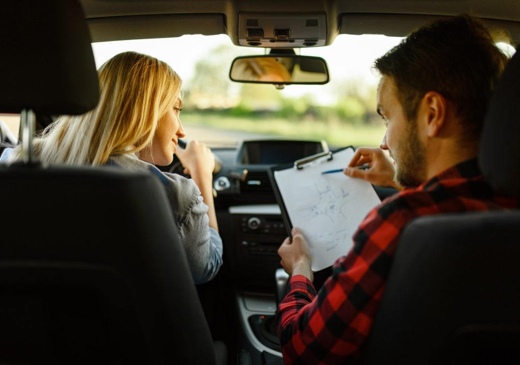 instructor-helps-woman-to-drive-the-car.jpg